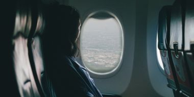 Woman looking out of an airplane window